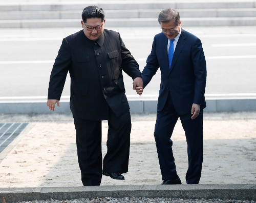 27일 판문점 군사분계선에서 만난 문재인 대통령과 김정은 북한 국무위원장이 깜짝 월경하는 진풍경을 연출했다. 한국공동사진기자단.