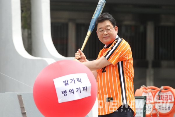 '발가락 병역기피' 문구가 붙여진 풍선을 터트리고 있는 박성효 후보.