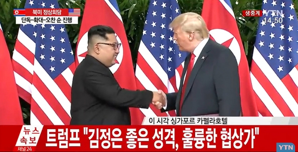 김정은 북한 국무위원장과 도널드 트럼프 미국 대통령이 12일 오후 정상회담을 마친 뒤 공동합의문에 서명하고 악수를 나누고 있다. YTN 영상 캡처.