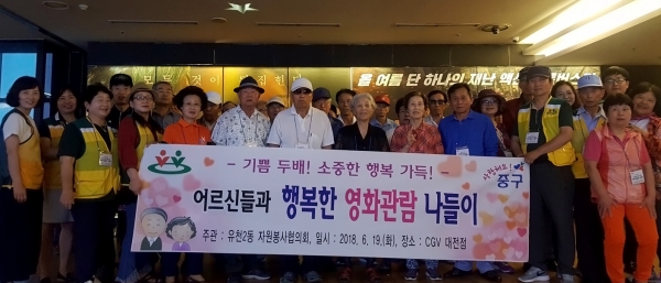 영화관 앞에서 기념사진을 촬영한 유천2동 어르신들과 자원봉사협의회원들