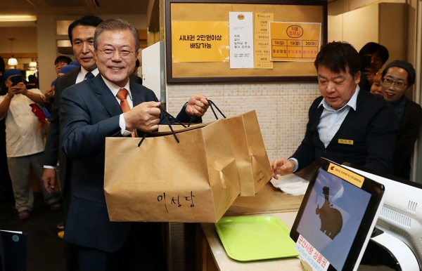 지난 30일 전북 군산을 방문한 문 대통령이 지역 유명 빵집인 '이성당'에서 빵을 사 들어보이고 있다. 청와대 제공
