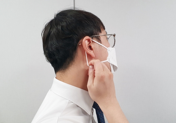 한 직장인이 장시간 마스크 착용으로 인한 귀 통증을 호소하고 있다.