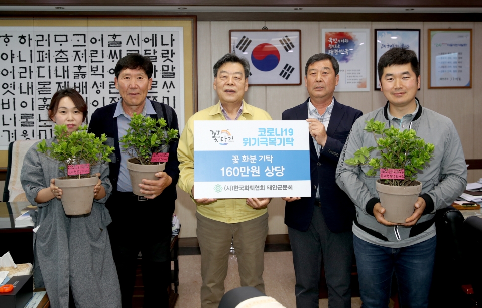 한국화훼협회 태안군분회 김남한 회장(오른쪽 두 번째)이 4일 가세로 군수(왼쪽 세 번째)에게 꽃 화분을 기탁했다.