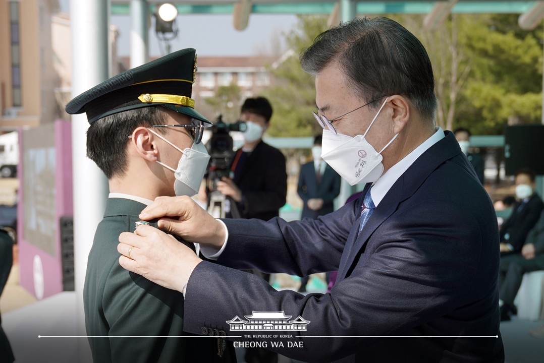 문재인 대통령이 올해 3월 국군간호사관학교 임관식에 참여한 모습. 청보리 작가가 쓴 글씨가 마스크에 인쇄돼있다. (사진=청와대)