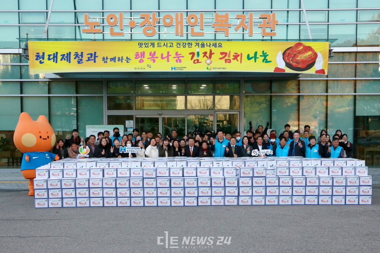 현대제철 당진제철소 임직원이 지역사회와 함께 18일 당진시복지타운에서 관내 복지시설과 저소득층 가구를 대상으로 전달할 김장 김치 나눔 활동을 앞두고 기념 촬영을 하고 있다. 현대제철 당진제철소