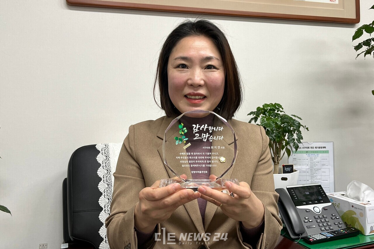 최지연 대전 서구의원이 정뱅이마을 주민에게 받은 감사패를 들고 있다. 유솔아 기자. 